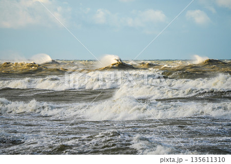 Powerful Baltic Sea storm waves crashing under cloudy sky, dynamic seascape with high surf and sea spray Powerful Baltic Sea storm waves crashing under cloudy sky, dynamic seascape with high surf and sea spray 135611310