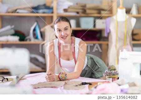 woman dressmaker invites clients to the workshop 135614082