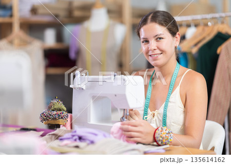 Woman dressmaker sewing clothes Woman dressmaker sewing clothes 135614162