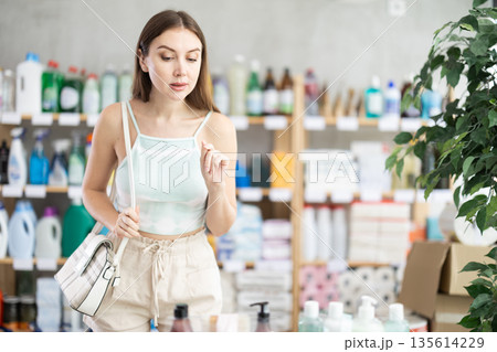 Woman looking with interest at the shelves in the supermarket 135614229