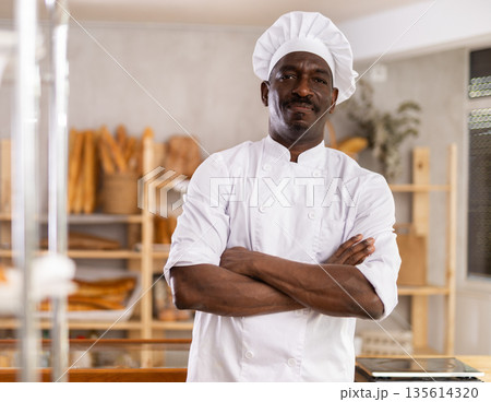 Portrait of positive man baker Portrait of positive man baker 135614320