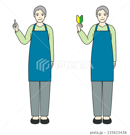 青いエプロン姿で指差しと初心者マークを掲げるシニア男性 青いエプロン姿で指差しと初心者マークを掲げるシニア男性 135615436
