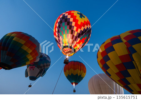 colorful hot air balloons glowing against sky 135615751