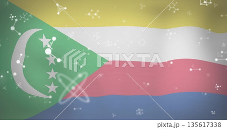 Waving Comoros flag illustration across frame, featuring crescent, stars and floating science icons 135617338