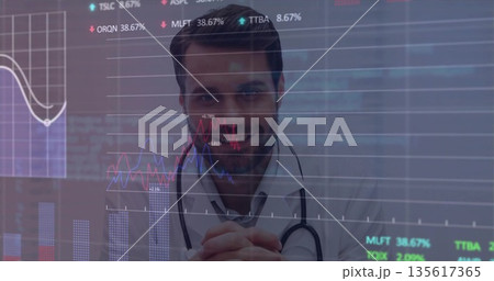 Doctor analyzing overlaid charts with percentage labels on display in lab at desk, with stethoscope 135617365