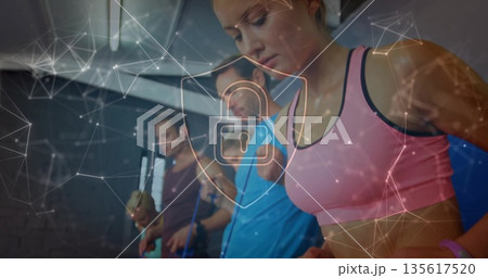 Pink-clad exerciser jumping rope with group in gym, with digital network lock overlay, copy space Pink-clad exerciser jumping rope with group in gym, with digital network lock overlay, copy space 135617520