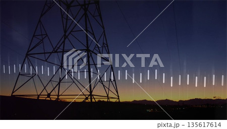 Looming transmission tower spanning ridge at dusk, with power lines, white bar overlay, copy space 135617614
