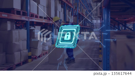 Male worker wearing hard hat lifting cardboard box in warehouse, with metal racks, padlock graphic Male worker wearing hard hat lifting cardboard box in warehouse, with metal racks, padlock graphic 135617644