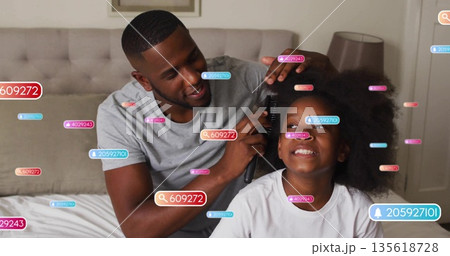 Father combing daughter's hair on bed in bedroom, with hairbrush, tufted headboard and lamp Father combing daughter's hair on bed in bedroom, with hairbrush, tufted headboard and lamp 135618728