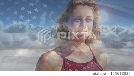 Smiling adult woman wearing red patterned sleeveless top against cloudy sky, with US flag overlay Smiling adult woman wearing red patterned sleeveless top against cloudy sky, with US flag overlay 135618823