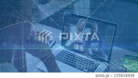 Conducting remote meeting user viewing laptop at office with smartphone tablet and data overlays Conducting remote meeting user viewing laptop at office with smartphone tablet and data overlays 135618936