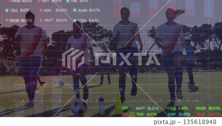 Jogging female soccer team training on grass field, with cones, soccer balls and financial overlay Jogging female soccer team training on grass field, with cones, soccer balls and financial overlay 135618948
