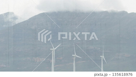 Standing three wind turbines rotating blades on mountain hillside, with clouds and rocky ground Standing three wind turbines rotating blades on mountain hillside, with clouds and rocky ground 135618976