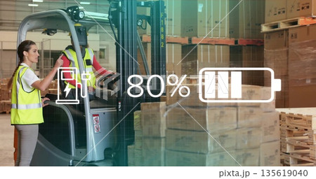 Warehouse staff wearing yellow vests monitoring electric forklift battery with overlay, copy space 135619040