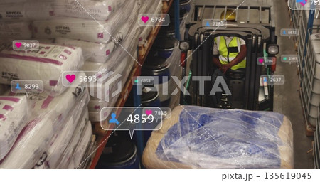 Operator wearing safety vest moving pallet on forklift in warehouse, with social icons, copy space 135619045