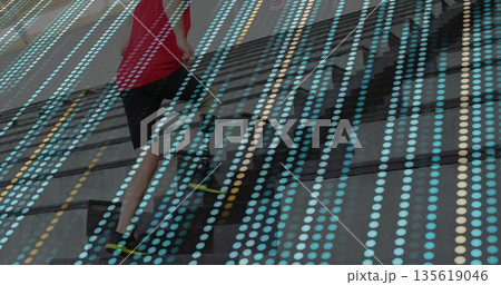 Running male in sportswear powering up outdoor stairs, with running shoes, dot overlay, copy space 135619046