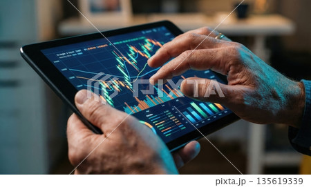 Businessman analyzing financial growth graph with holographic chart 135619339