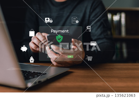 A person uses a smartphone for secure online payment with glowing digital icons of shopping, credit card, savings, tax, and healthcare, symbolizing financial technology and secure transactions. 135621063