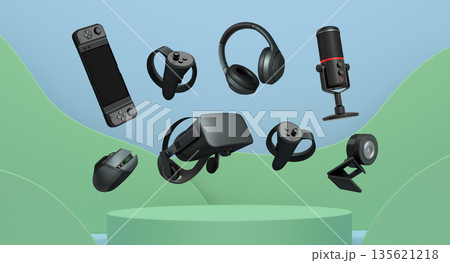 Assorted gaming gadgets like controllers, VR headset, mouse, and mic floating above circular podium and white platform 135621218