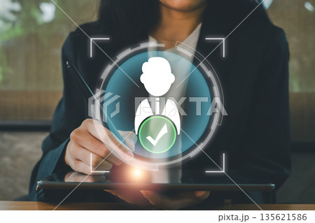 Businesswoman interacting with digital tablet, highlighting a virtual checkmark icon symbolizing successful verification or approval. Businesswoman interacting with digital tablet, highlighting a virtual checkmark icon symbolizing successful verification or approval. 135621586