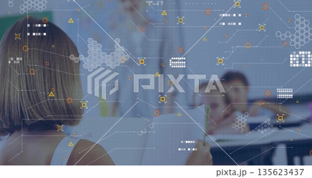 Teaching female teacher holding tablet front of classroom, with holographic overlays, copy space 135623437