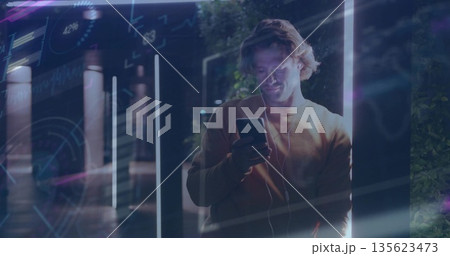 Using smartphone man wearing sweatshirt on night walkway: wired earphones, LED bars, data overlays Using smartphone man wearing sweatshirt on night walkway: wired earphones, LED bars, data overlays 135623473