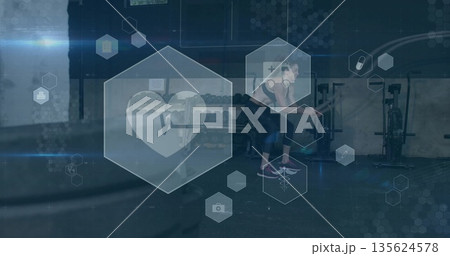 Lifting female athlete performing barbell deadlift on gym floor with hexagonal overlays, copy space Lifting female athlete performing barbell deadlift on gym floor with hexagonal overlays, copy space 135624578