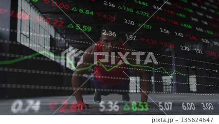 Man doing push-up in red sleeveless top at gym, with floating stock tickers and line graph Man doing push-up in red sleeveless top at gym, with floating stock tickers and line graph 135624647