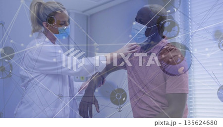 Placing hand on shoulder, female doctor comforting male patient in clinic, with lab coat and masks Placing hand on shoulder, female doctor comforting male patient in clinic, with lab coat and masks 135624680