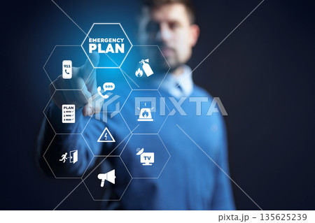 Person interacting with digital emergency plan display in a dark setting 135625239