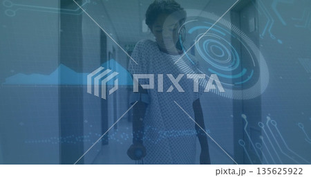 Walking girl talking on smartphone using crutches in hospital corridor, with interface overlay Walking girl talking on smartphone using crutches in hospital corridor, with interface overlay 135625922