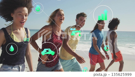 Walking five friends wearing swimwear and shorts on sunlit beach, with digital eco financial icons 135625999