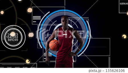 Holding basketball under right arm male athlete in maroon jersey in studio displaying HUD elements Holding basketball under right arm male athlete in maroon jersey in studio displaying HUD elements 135626106