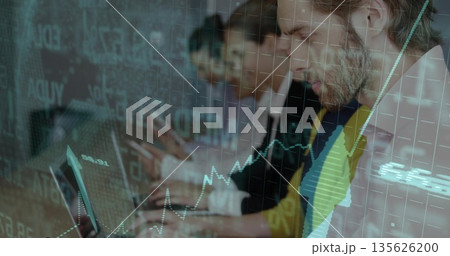 Bearded man in blazer reviewing chart on laptop in trading office with data overlay, copy space 135626200