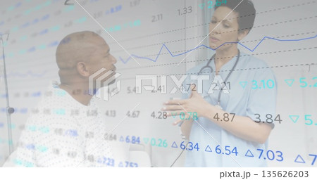 Patient in white gown and nurse in blue scrubs reviewing chart overlay in clinic, with stethoscope 135626203