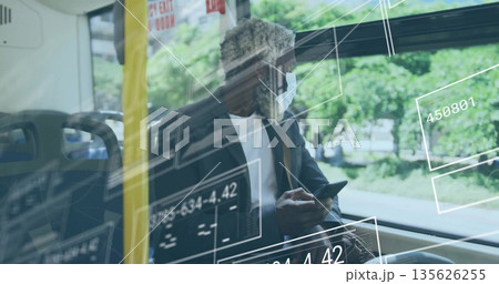 Commuter in face mask, suit jacket using smartphone on train by window, with data overlays 135626255