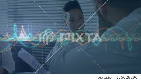 Colleagues discussing report with charts in conference room, waveform overlay above paper cup 135626290