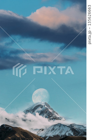 Georgia. Peak Of Mount Kazbek Covered With Snow. Kazbek Is A Stratovolcano And One Of Major Mountains Of Caucasus. Beautiful Georgian Nature Landscape In Early Winter. Georgia. Peak Of Mount Kazbek Covered With Snow. Kazbek Is A Stratovolcano And One Of Major Mountains Of Caucasus. Beautiful Georgian Nature Landscape In Early Winter. 135626663