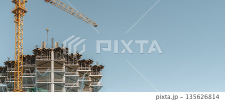 Construction of a building banner background. Construction site with crane. Business, development, industry. 135626814