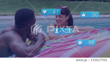 Leaning adult couple in swimwear chatting poolside in backyard, with swirl float and reaction icons Leaning adult couple in swimwear chatting poolside in backyard, with swirl float and reaction icons 135627302