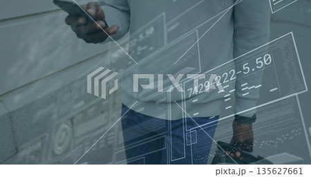 Businessman holding smartphone and briefcase by paneled wall, with digital panels and readouts Businessman holding smartphone and briefcase by paneled wall, with digital panels and readouts 135627661