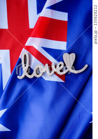 Wooden word LOVE on background of National symbol of Australia flag background. Copy space for your text. Concept Wooden word LOVE on background of National symbol of Australia flag background. Copy space for your text. Concept 135628212
