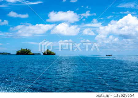 Boat near an islet of the Togian Islands, Sulawesi, Indonesia 135629554