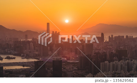 Jan 11 2026 Kowloon skyline glowing under warm golden sunset light 135629562