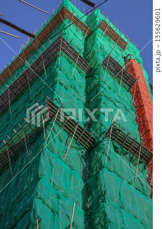 Sept 14 2025 High-Rise Construction Covered in Safety Nets Against Clear Sky Sept 14 2025 High-Rise Construction Covered in Safety Nets Against Clear Sky 135629601
