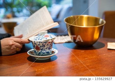 Enjoying tea and reading in a cafe in Chengdu Sichuan China 135629927