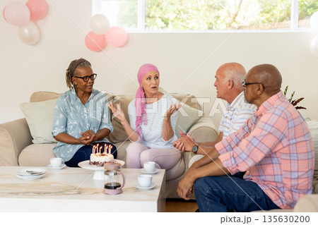 Celebrating birthday, senior friends with cake and coffee, having lively conversation Celebrating birthday, senior friends with cake and coffee, having lively conversation 135630200