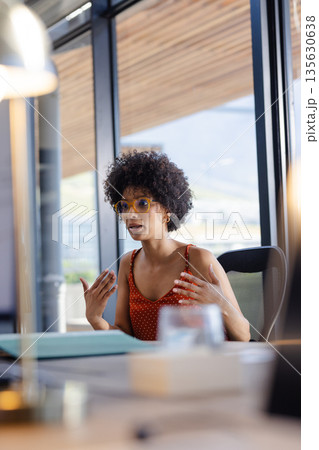 Businesswoman in office discussing ideas passionately during meeting with colleagues 135630638