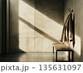 A half-empty cloakroom with a single coat left 135631097