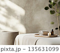 A minimalist spa room with an elegant massage table, a small tray with essential oils 135631099